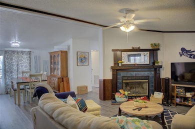 Living area featuring a textured ceiling, visible 