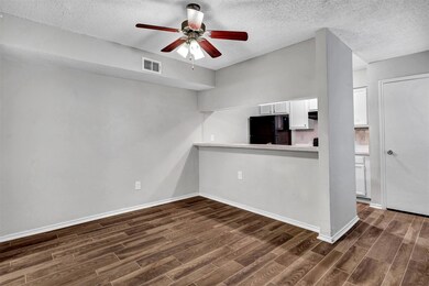 View of DR w/ ceiling fan looking over bar into Ki