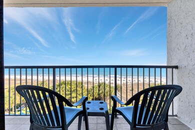 Balcony with a water view and a view of the beach