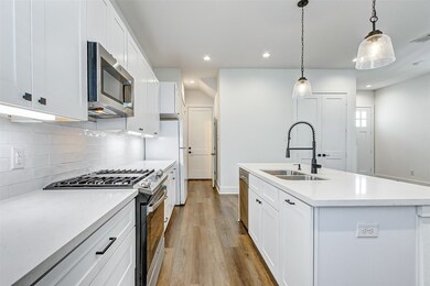 View of kitchen extending to the garage at end of