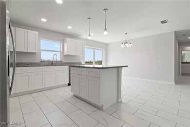 Kitchen featuring marble finish floor, stainless s