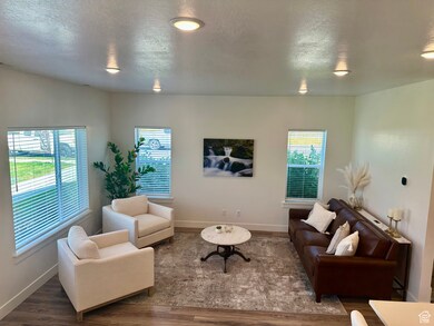 Light and inviting living area with a textured ceiling and plenty of floor space