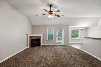 Unfurnished living room featuring a tile fireplace