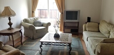 Bright Living room that leads out to a patio