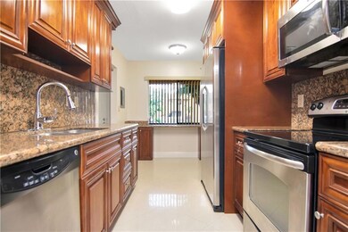 SS Appliances and Granite Counter Tops with an eat