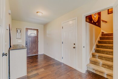 Stairs to bonus room also conveniently located here. Door is perfect when room is not in use or needs privacy.