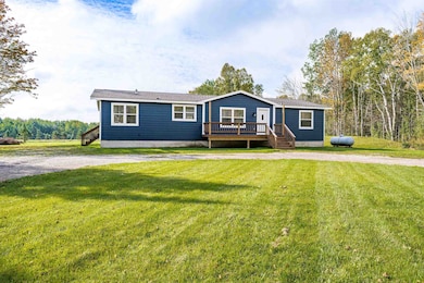 View of front of home featuring a front lawn, New side entry stairway, and approx. 6'x20' Newer Deck (2024).