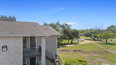 View of property exterior with a shingled roof and a lawn