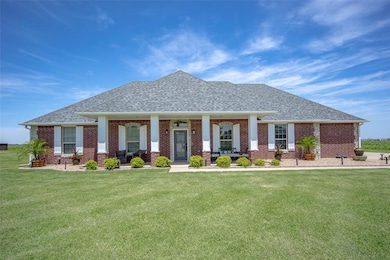 View of front of home with a shingled roof, covere