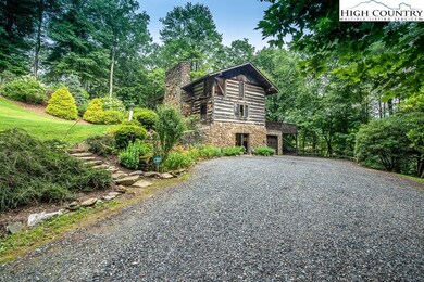 Journey up the driveway by lush rhododendron and g