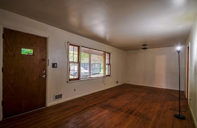 Entryway featuring dark wood-style flooring, visib