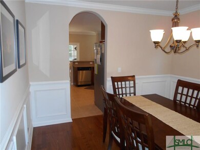 Formal Dining Room Leading to Kitchen with Arched 