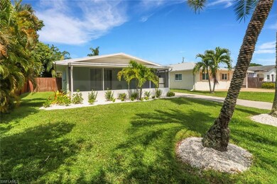 Single story home with a front lawn and a sunroom