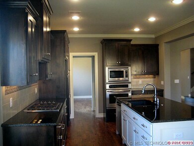 Granite, island kitchen with stainless steel appli