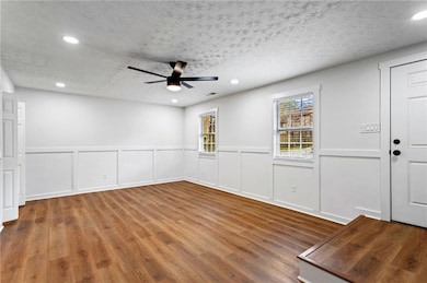 Unfurnished room featuring recessed lighting, a te