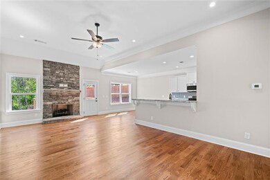 Unfurnished living room featuring a ceiling fan, c