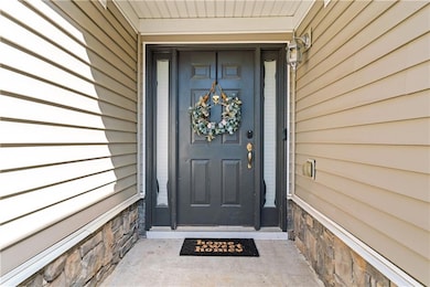 Doorway to property featuring stone siding