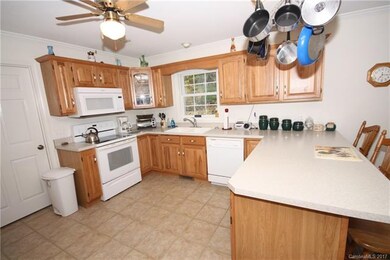 Kitchen has sweet oak cabinets and tile floors. Ve