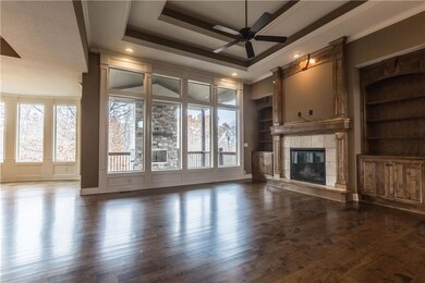 Great room looking out to the covered deck with fi