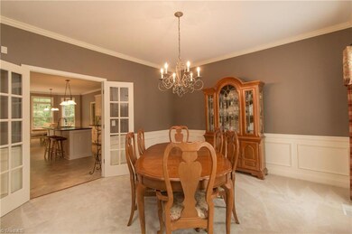 Dining room with wainscoting and access to the kitchen