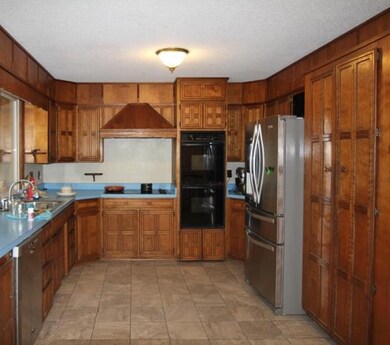 Kitchen with cook top and double ovens.