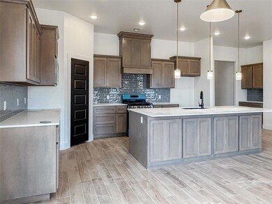 Kitchen with stainless steel gas range, a sink, li