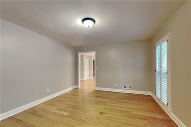 Unfurnished room featuring light wood-style flooring and baseboards