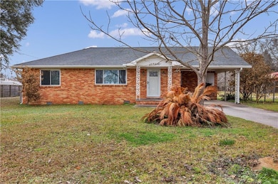 Ranch-style house with a front lawn