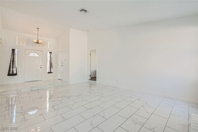 Living Room with view of Entry & Primary Bedroom a