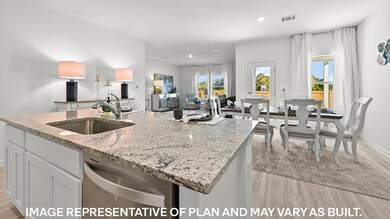 Kitchen featuring a center island with sink, sink,
