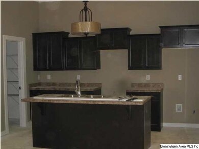 Kitchen with island where family and guest can sit
