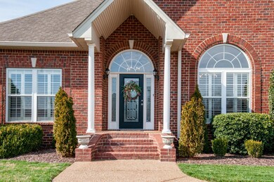 The home has an inviting Covered front porch with columns and brick steps. 