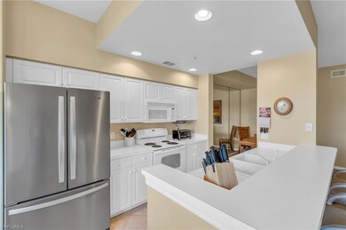 Kitchen featuring a kitchen breakfast bar, white c