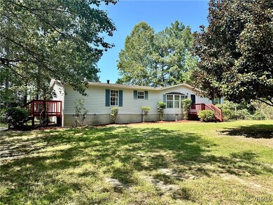 Back of property featuring a yard and a deck