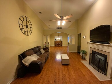 Living room featuring ceiling fan with notable cha