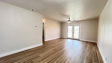 Spare room with french doors, baseboards, visible