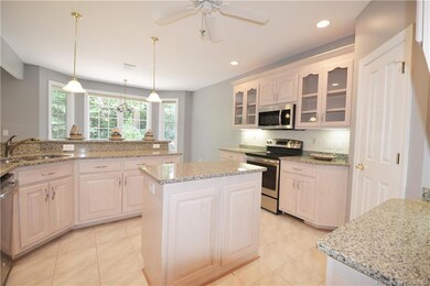 Kitchen has island and breakfast bar.