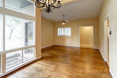 Looking back towards to formal living area you can glance out the window of the porch entrance and note the decorative mid-century accents.