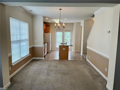 View of the dining room from within the living room. Dual windows and crown/chair moldings.