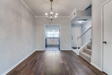 Foyer featuring a chandelier, wood flooring, and o