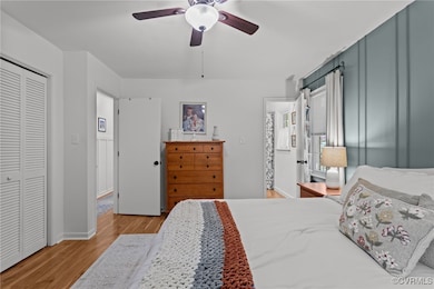 Bedroom with baseboards, LVP, a ceiling fan, custo