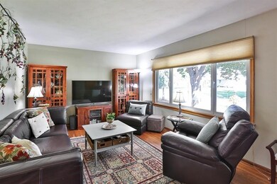 Sun-filled living room with hardwood floors and la