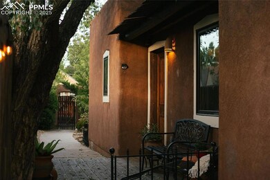 View of home's exterior featuring a patio, a gate,