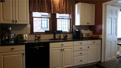 Kitchen has stunning granite countertops and honed marble floors.