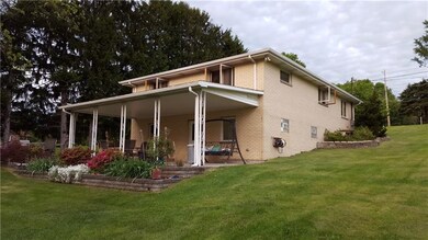 Rear picture of the home with a huge patio and add