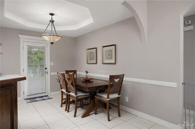 Dining room featuring a raised ceiling and light tile patterned floors