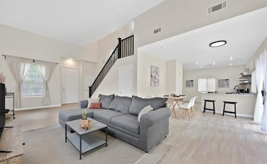 Living room with light wood-type flooring, visible
