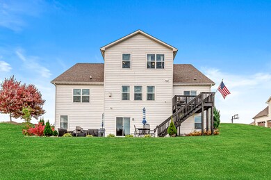 Exterior back, upper deck and concrete patio.