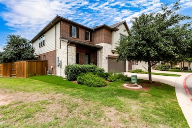 View of front of home featuring stone siding, dri