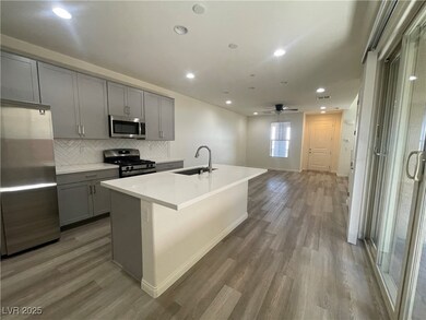 Kitchen with gray cabinetry, stainless steel appli